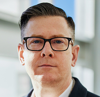 Portret van Alexander Hughes, CEO en executive van een cryptohandelsbedrijf